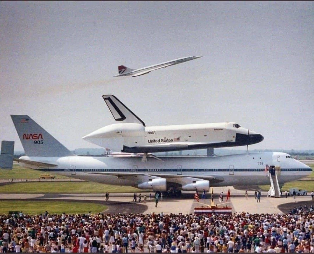 Space Shuttle on a NASA carrier aircraft with Concorde flying overhead