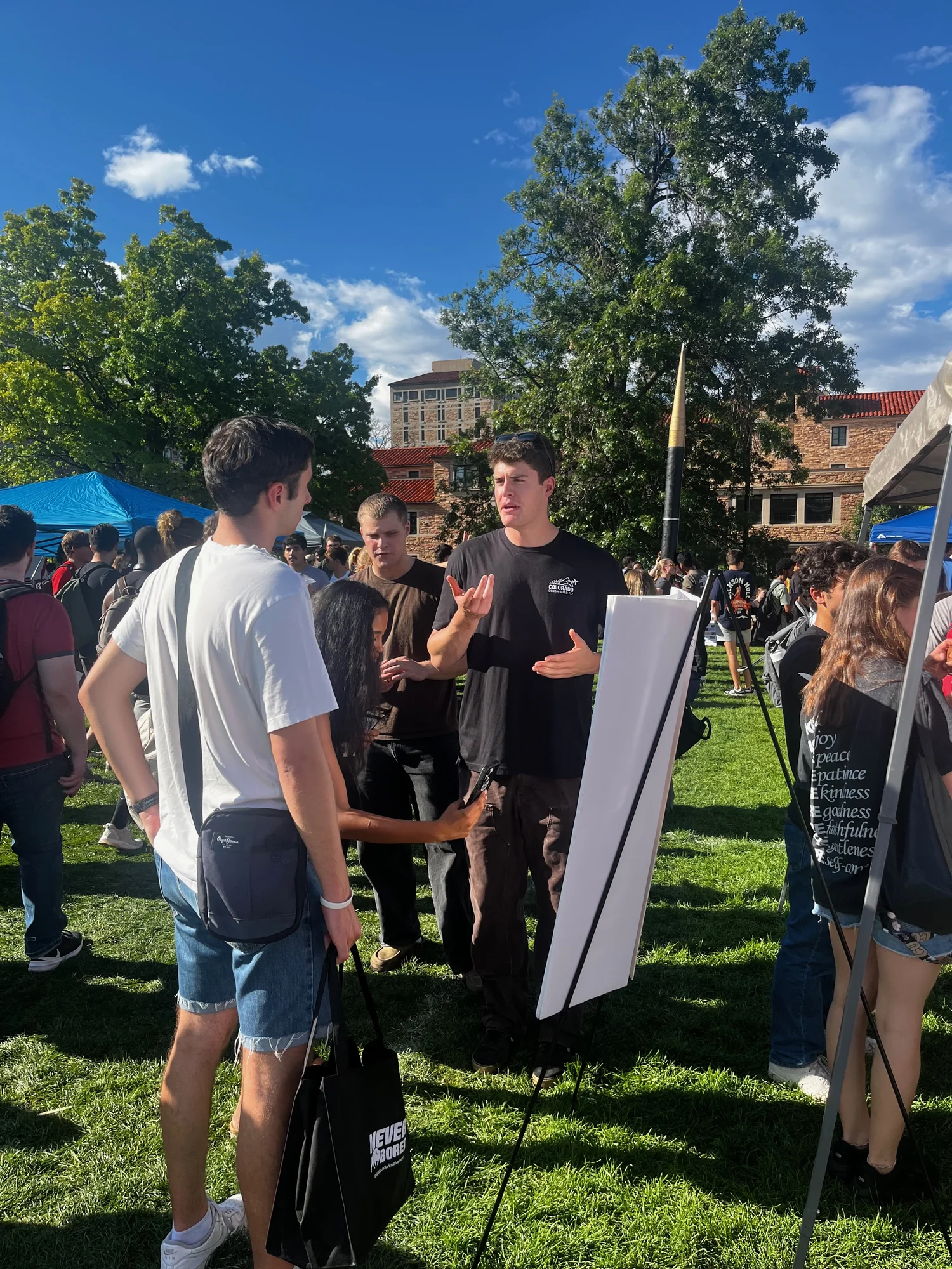 Ryan Cross explaining Design Build Fly at a student outreach event