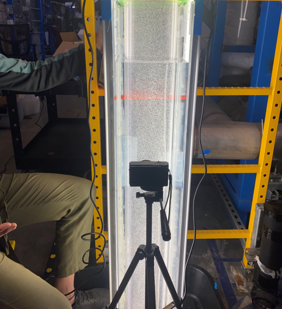 Water-filled tube with bubbles and a camera used to measure void fraction